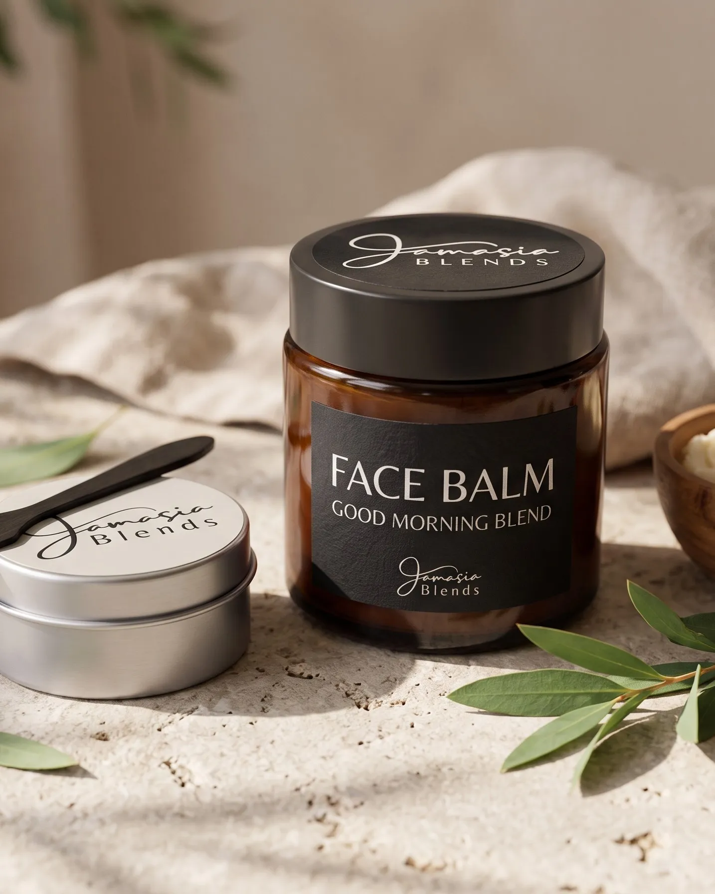 Jamasia Blends Face Balm, Good Morning Blend, in an amber jar beside a travel tin